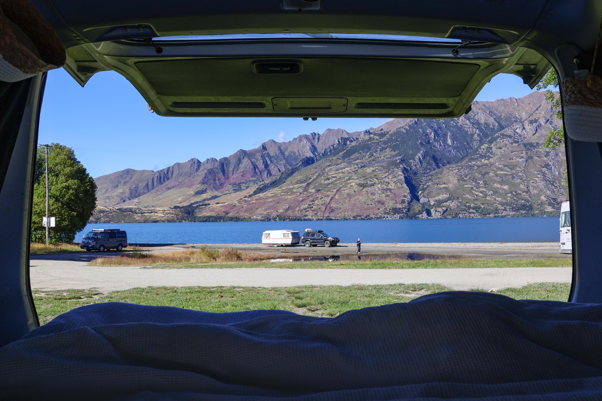 View of a New Zealand lake from inside a campervan