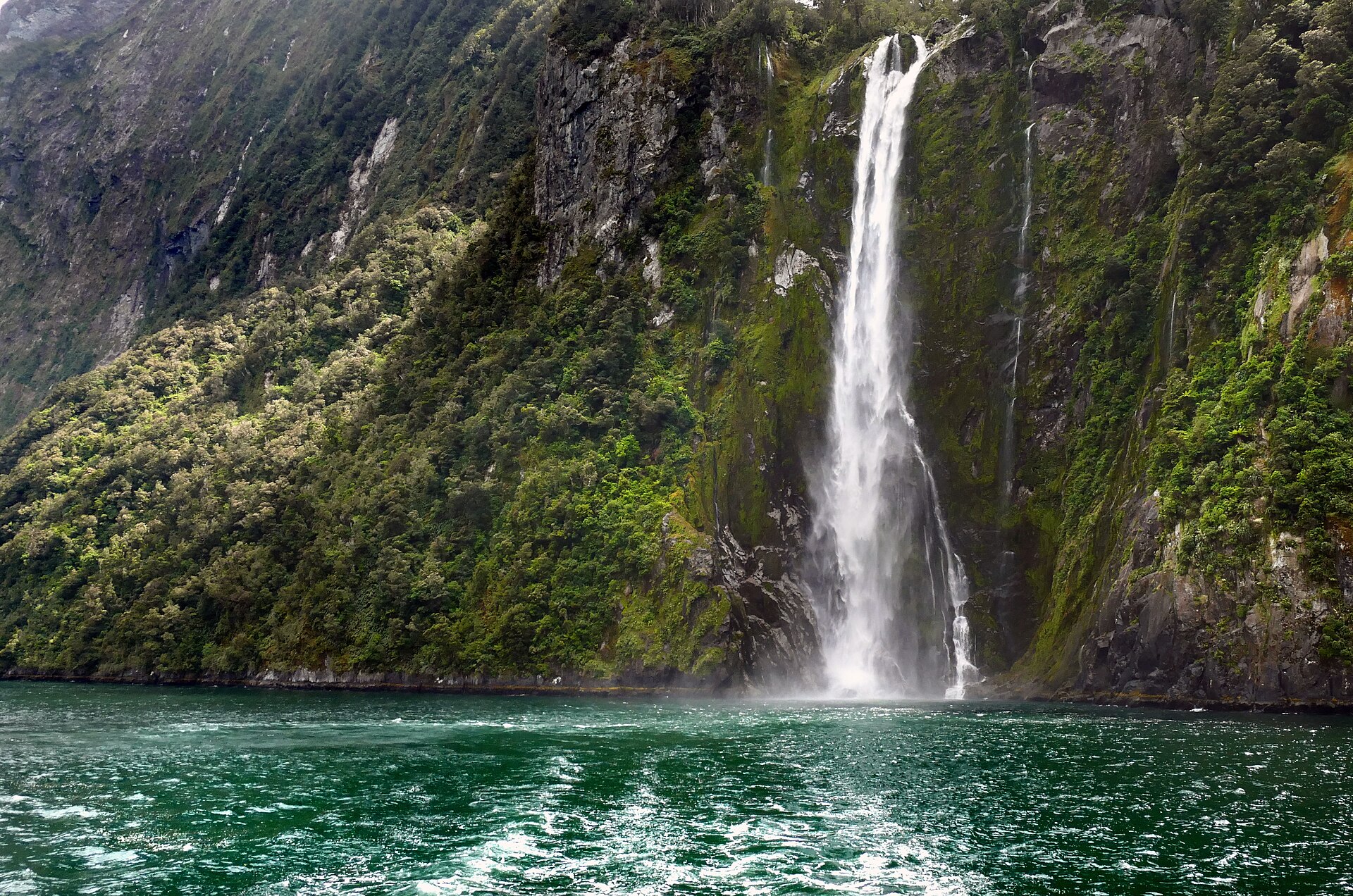 Stirling Falls 155 metre waterfall dropping into Milford Sound fjord in New Zealand